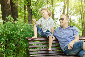 Image showing Father and son playing at the park at the day time.