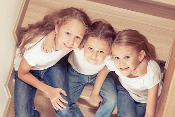 Image showing Portrait of happy children which are sitting on the stairs in th