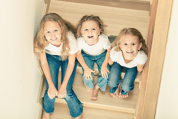 Image showing Portrait of happy children which are sitting on the stairs in th