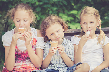 Image showing Three happy children  playing in the park at the day time.