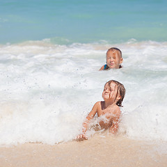 Image showing Sister and brother playing on the beach at the day time.