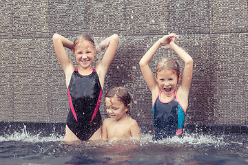 Image showing happy children  playing on the swimming pool