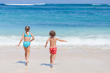 Image showing Sister and brother playing on the beach at the day time.