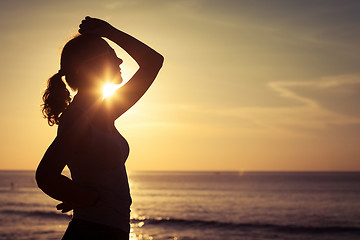 Image showing woman open arms under the sunrise at sea