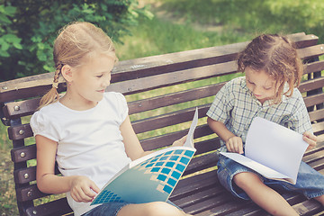 Image showing Three happy children  playing in park