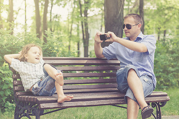 Image showing Father and son playing at the park at the day time.