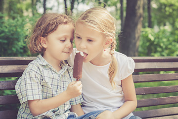 Image showing Two happy children  playing in the park at the day time. 