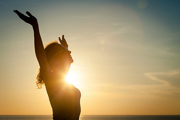 Image showing woman open arms under the sunrise at sea