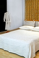Image showing Bathrobe and bed