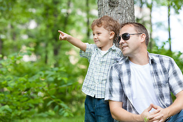 Image showing Father and son playing in the park at the day time.