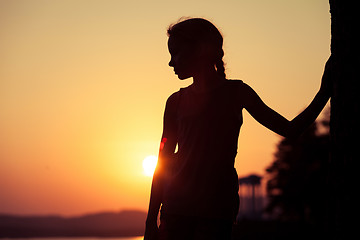 Image showing Portrait of sad blond little girl standing on the beach