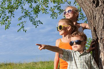 Image showing Three happy children  playing in the park at the day time.