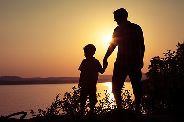 Image showing father and son playing on the coast of lake