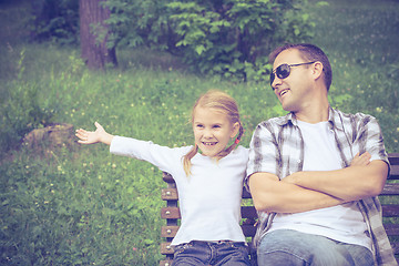 Image showing Father and daughter playing at the park at the day time.