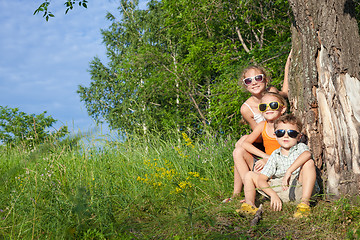 Image showing Three happy children  playing in the park at the day time.