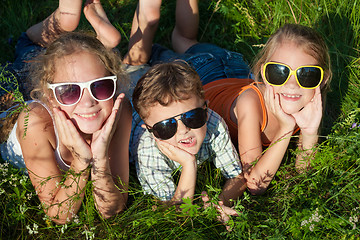 Image showing Three happy children  playing in the park at the day time.