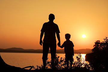 Image showing father and son playing on the coast of lake