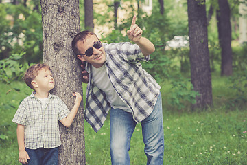 Image showing Father and son playing in the park at the day time.