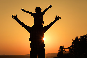 Image showing father and son playing on the coast of lake