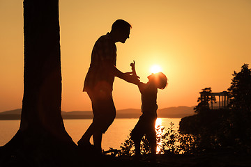 Image showing father and son playing on the coast of lake