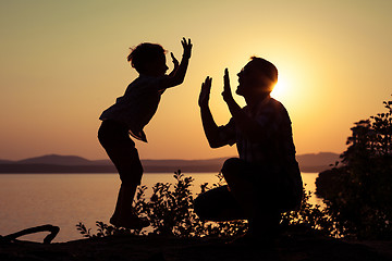 Image showing father and son playing on the coast of lake