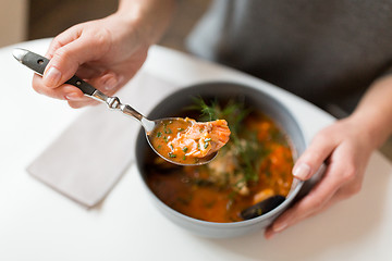 Image showing woman eating seafood soup at restaurant