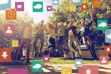 Image showing happy teenage students or friends jumping outdoors