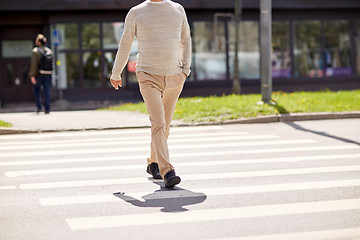 Image showing senior man walking along city crosswalk