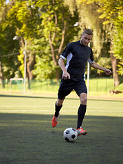 Image showing soccer player playing with ball on football field