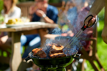 Image showing man cooking meat on barbecue grill at summer party