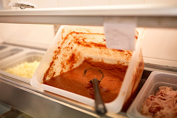 Image showing container with tomato sauce at restaurant kitchen