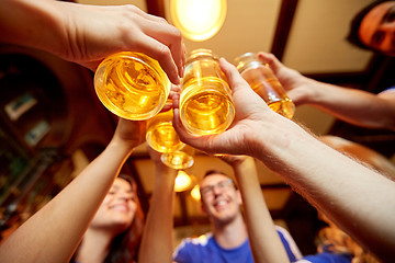 Image showing football fans clinking beer glasses at sport bar