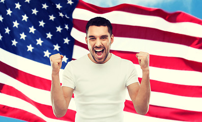 Image showing angry man showing fists over american flag