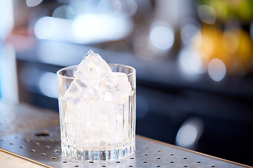 Image showing glass with ice cubes at cocktail bar