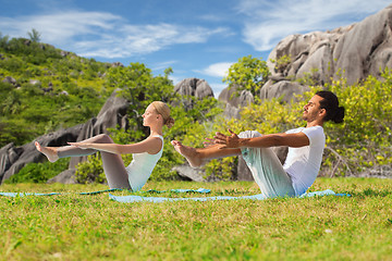 Image showing couple making yoga half-boat pose outdoors