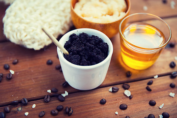 Image showing close up of coffee scrub in cup and honey on wood