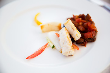 Image showing white fish with stewed eggplant garnish on plate