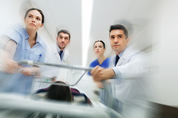 Image showing medics and patient on hospital gurney at emergency