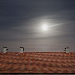 Image showing tiled top of the roof, cloudy blue sky