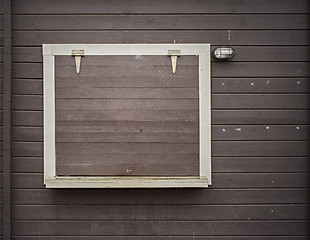 Image showing White frame on the grunge wooden plank wall
