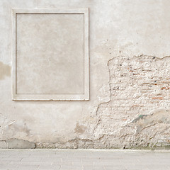 Image showing abandoned cracked brick wall with a stucco frame