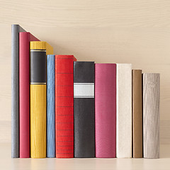 Image showing stack of books in the bookself