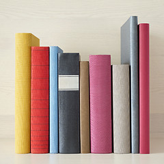 Image showing stack of books in the bookself