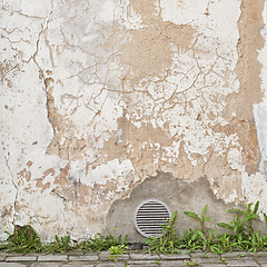 Image showing abandoned cracked stucco wall with ventilation grille