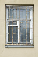 Image showing abandoned grunge cracked stucco wall with window grilles