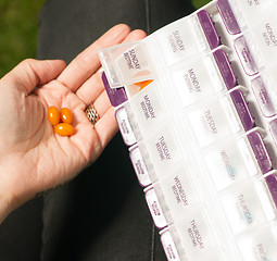 Image showing Woman Takes Last Day Sunday Medication Vitamins