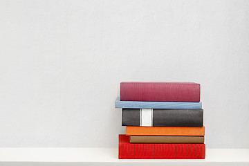 Image showing stack of books in the bookself