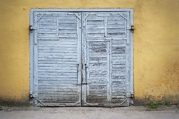 Image showing grunge wooden plank door, dirty stucco wall background