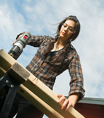 Image showing Craftsperson Woman Uses Power Screwdriver Drilling Holes Wood