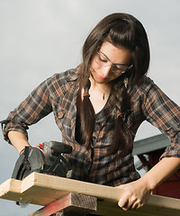 Image showing Craftsperson Woman Uses Circular Saw Cutting Wood